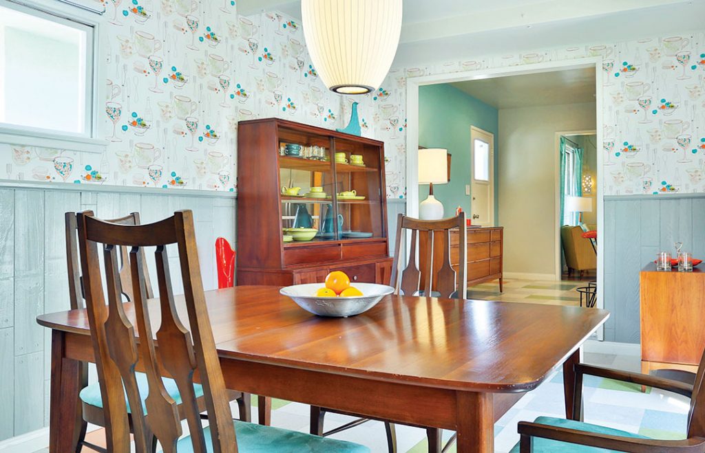 retro mid century modern dining room with light blue wallpaper and