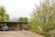 homeowner and dog walk outside carport of 1960s Altadena home