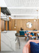 wood paneling and floating glass shelves above bar in Palm Springs home