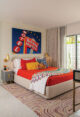 retro motel sign art print as focal point in bedroom of renovated 1957 Du Bois house