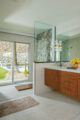 renovated primary bathroom with view to backyard pool