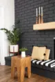 black painted brick fireplace with wooden candle holders