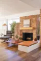 living room with brick fireplace and Eames lounge chair in 1959 Rossmoor home