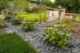 stone pillar and mini fence in MCM front yard with flowering plants