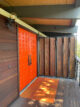 restored orange door and wood siding in 1961 La Jolla home