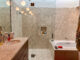 renovated bathroom with terrazzo shower and tub