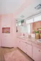 pink cabinetry and counter in Vivian's ensuite bathroom