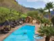 pool with black lounge chairs and guitar design on pool floor