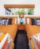 bedroom with two beds, Southwestern style blankets and turquoise lamp in Johnny Cash Ojai house