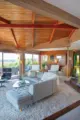 Eames lounge chair, curved sectional sofa, snake plants and shaggy carpet in renovated 1971 Oregon home