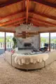 exposed wood beams and floor to ceiling windows make the open living room especially inviting