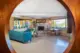 circular entryway into family room with fireplace and teal sofas in renovated 1971 Oregon home