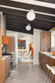 view of kitchen and terrazzo floors into dining room with George Nelson Bubble Lamp