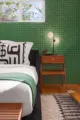 70s green wallpaper in master bedroom with a-frame nightstand