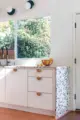 terrazzo counter tops and half circle wooden drawer pulls in renovated MCM kitche