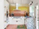 1956 kitchen renovation in LA home with colorful backsplash tile, terrazzo counters and pink tile floors