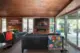 restored living room in Alcoa Care-Free Home with wood paneling, ceiling and clerestory windows