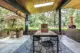 covered porch with skylight barbecue and planters