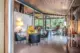 open concept from room with Eames lounge chair in restored Alcoa home