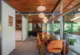 Saarinen dining chairs reupholstered in Knoll orange fabric in dining room of 1957 Virginia home