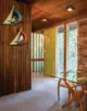 wood paneled walls and funky geometric screen in entryway of restored Alcoa Care-Free Home