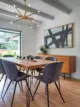 dining room featuring custom wood slab table Sputnik chandelier and black and white abstract painting