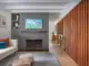 walnut screen divider screen and gray painted brick fireplace surround in renovated 1950 Kansas home