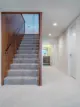 staircase from main level to lower level addition in 1950 Kansas home