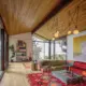 multi colored cushion and overside art in living room of 1958 Seattle home with a view to Puget Sound