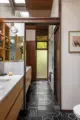 black and white tile floor and wood cabinetry in bathroom of renovated 1958 Seattle home