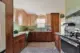 Handmade Zia tile backsplash in an earthy green with peach kitchen cabinets