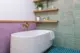 soaking tub and floating shelves in renovated Seattle bathroom