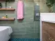 shower soaking tub built-in wood shelves and wooden vanity in renovated Seattle bathroom