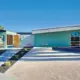 exterior of 1962 Palmer and Krisel home with turquoise and yellow paint colors