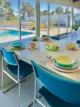 close-up of built-in quartz table and mid century multi-colored dishware