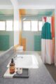 color block tile in teal orange and light blue in bathroom of mid century Long Beach home