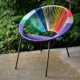 A rainbow colored Tres Chair by DDC&CoTrina Turk Celebrates Pride with This Colorful Window Installation Featuring The Tres Rainbow Chair Available For Pre-Sale. 