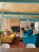 living room with a view and fireplace in renovated mid century home