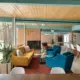 living room with a view and fireplace in renovated mid century home