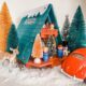 toy a-frame house surrounded by bottlebrush trees