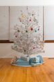 silver aluminum Christmas tree decorated with vintage ornaments