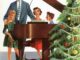 illustration of a 1950s family singing around the piano near a decorated Christmas tree