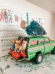 vintage Tonka wagoneer with bottlebrush tree strapped to the top