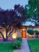 nighttime exterior view of 1957 Denver home with orange front door