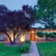 nighttime exterior view of 1957 Denver home with orange front door