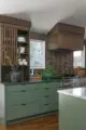 clay tile backsplash and green cabinetry in renovated modern kitchen