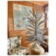 aluminum Christmas tree in wood paneled room